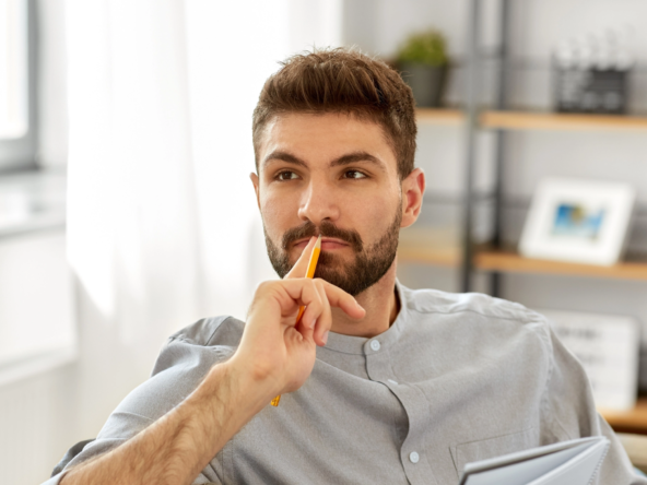 man on a with his hand on his lips and thinking