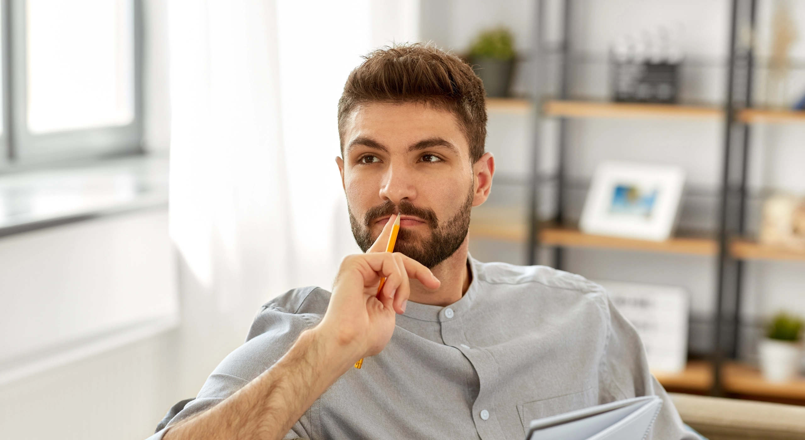 man on a with his hand on his lips and thinking