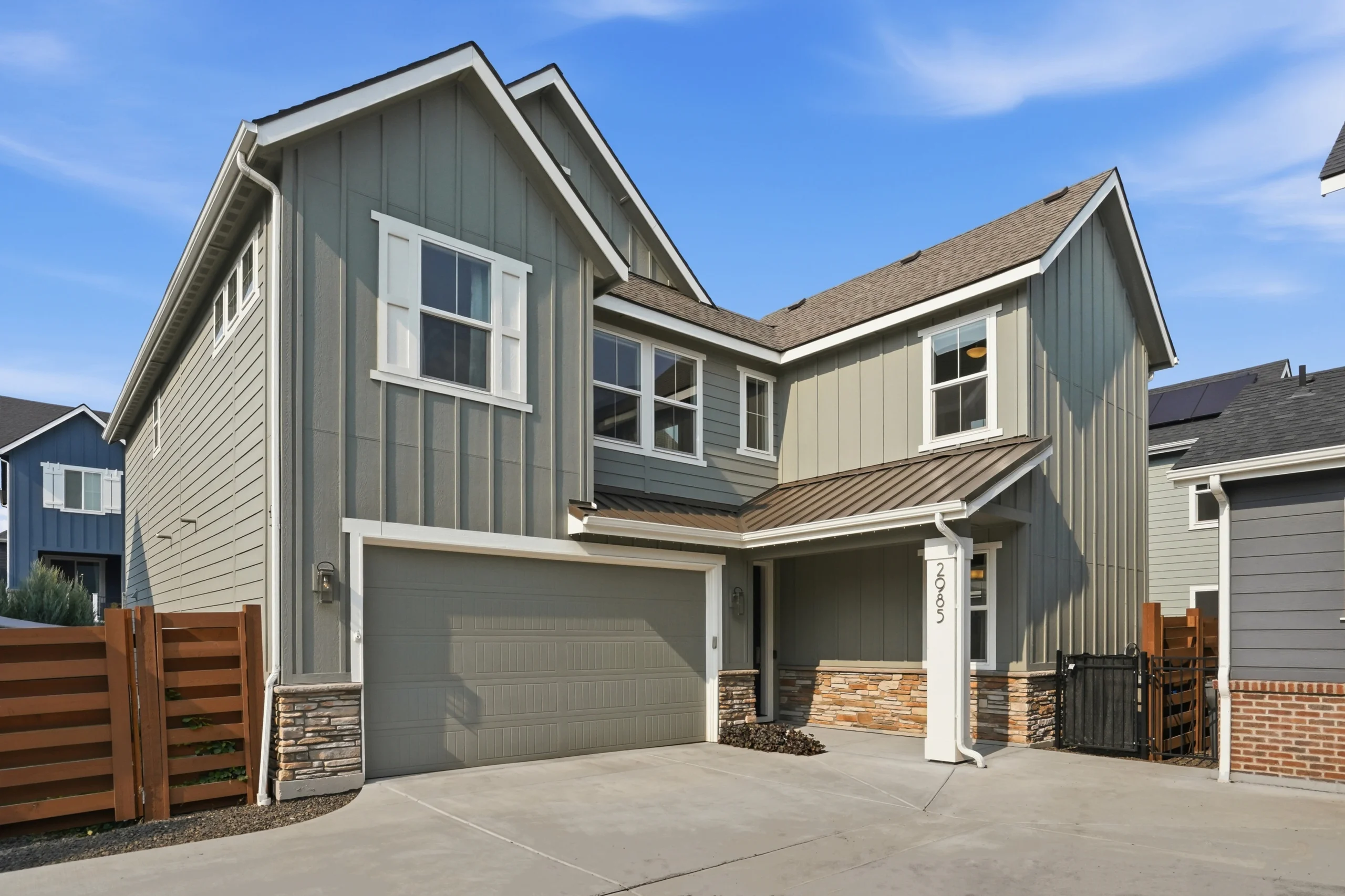 Front exterior of a modern 4-bedroom home in Southeast Boise, Idaho, built in 2020 with upgraded stone accents